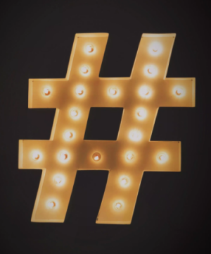 hashtag symbol shown in lights for the play #hashtag