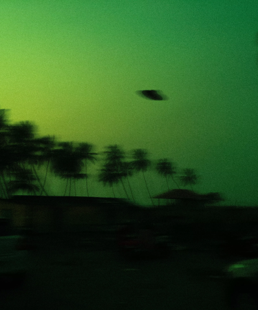 A UFO speeding over trees against an apocalyptic sky for the play Promapocalypse