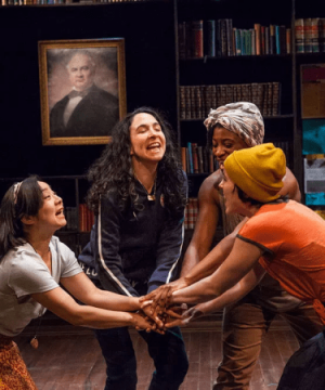 Four women on stage with 'hands in the middle' for the play Sensitive Guys