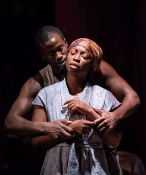 An African-American couple embrace on stage for the play Berta, Berta for TRW Plays